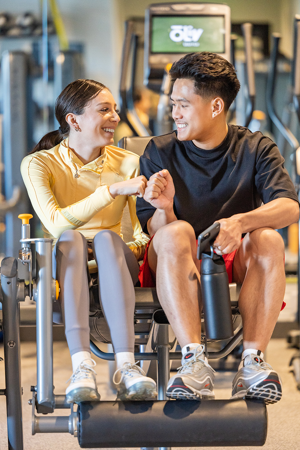 Two people sitting in a fitness center