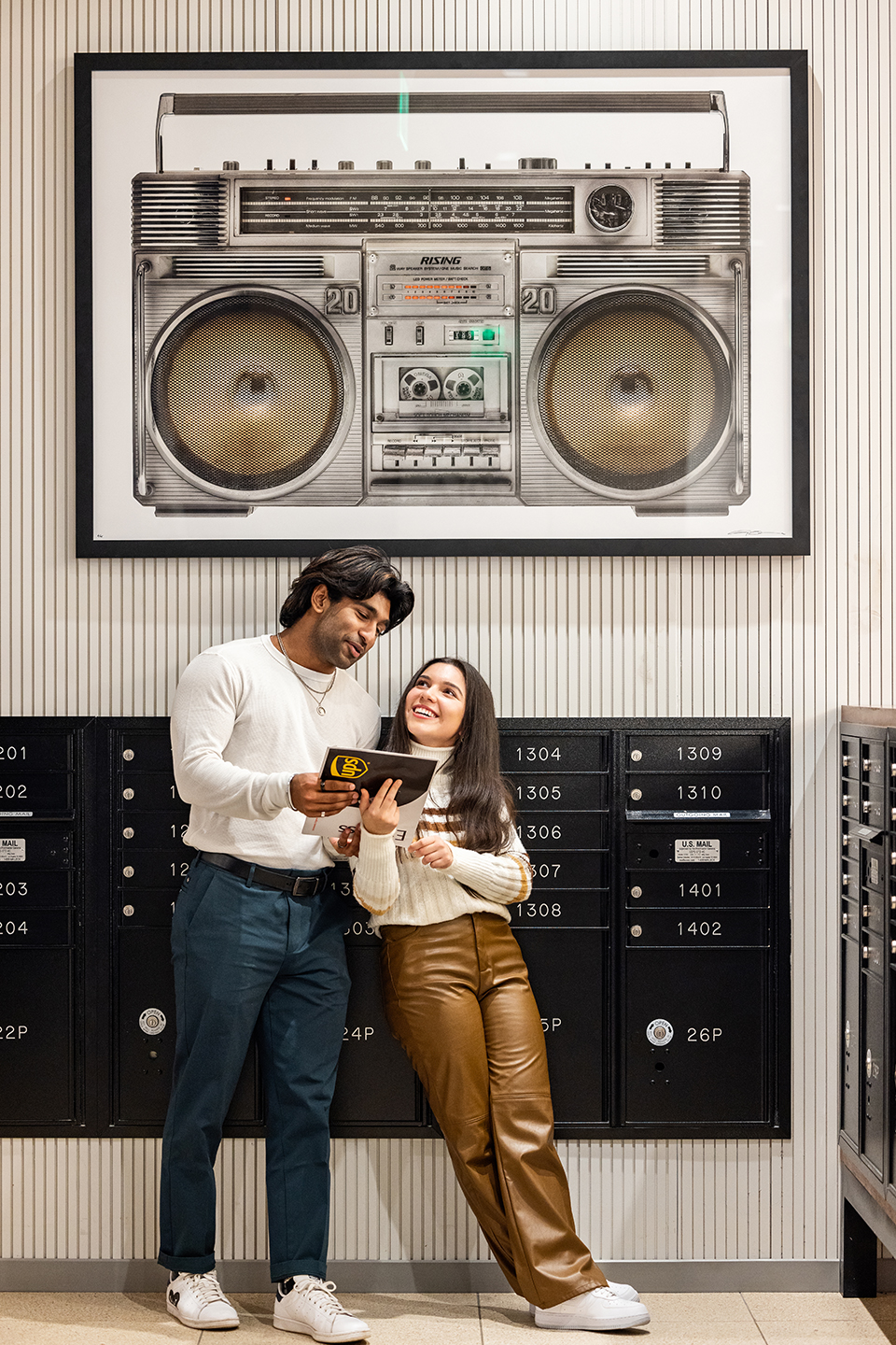 Two people standing in front of mailboxes