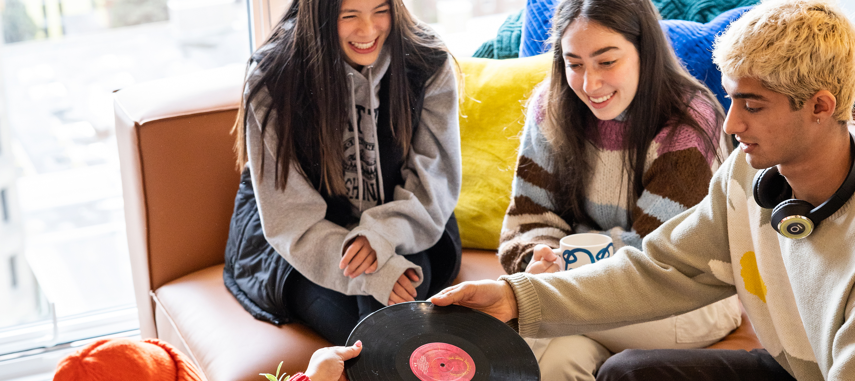 A group of friends looking at a vinyl record