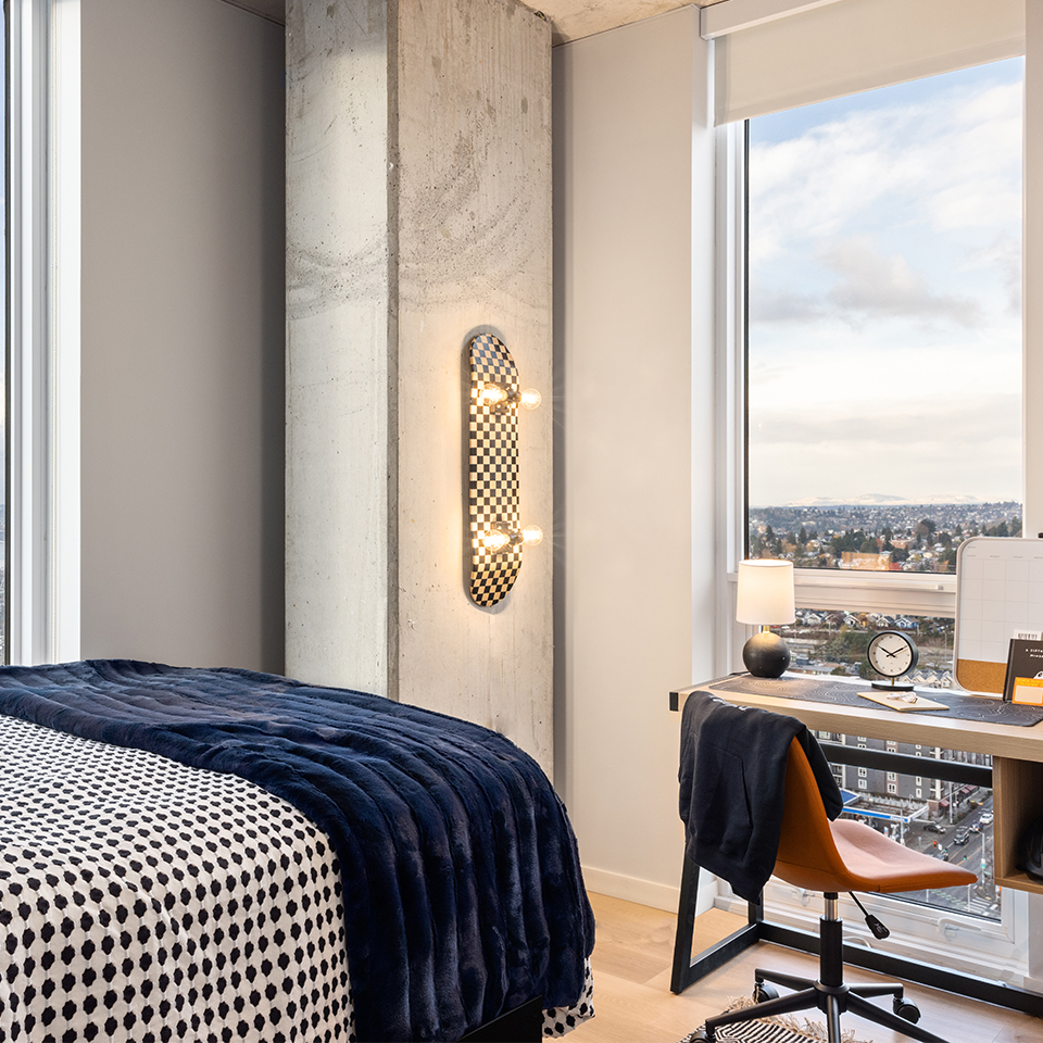 A bedroom with a desk